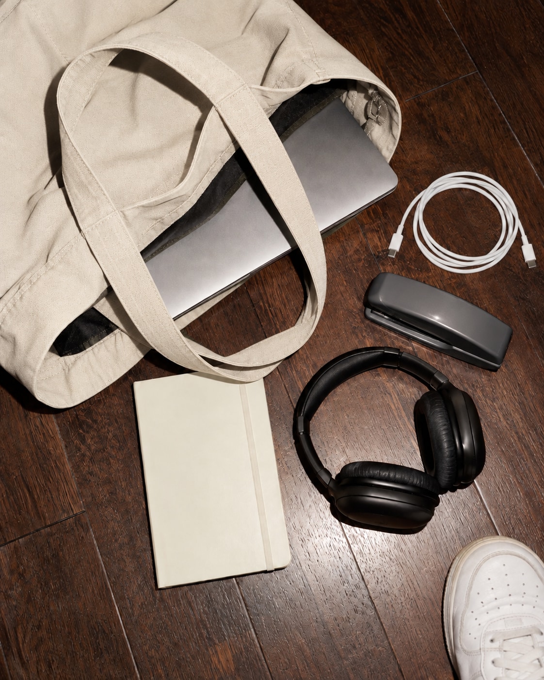 An canvas work bag with a laptop and everyday business essentials